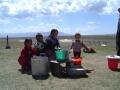 Children prepare fresh cream near the lake Son Kul